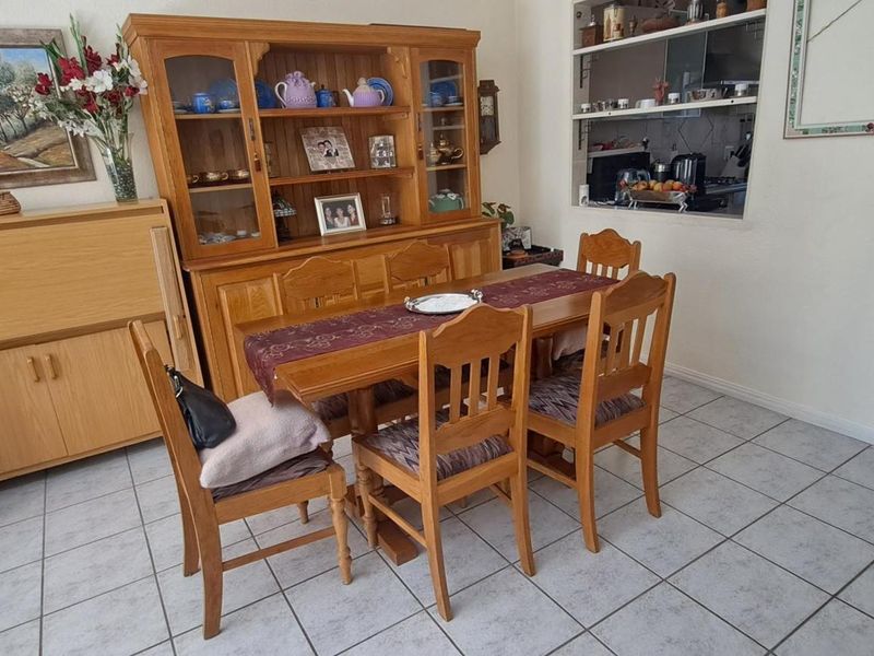 Dining area featuring tiled flooring and a convenient serving hatch connecting to the kitchen space.