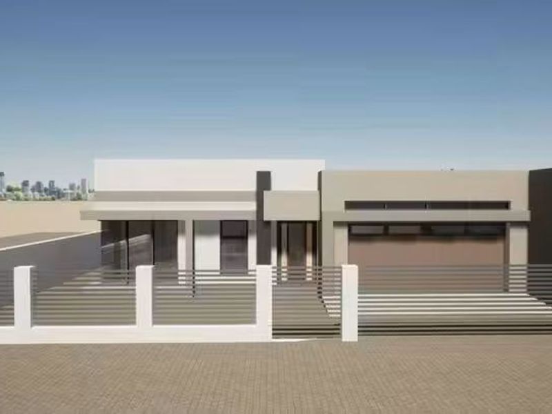 A modern single-story residential facade featuring clean lines, a secure gated entrance, and an integrated garage.