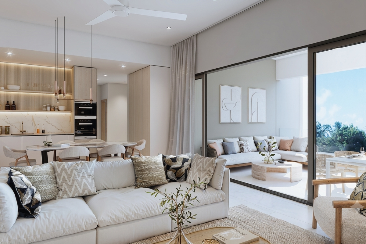 Modern open-plan living area featuring a sleek kitchen with integrated appliances, stone finishes, and seamless flow to a spacious covered balcony.