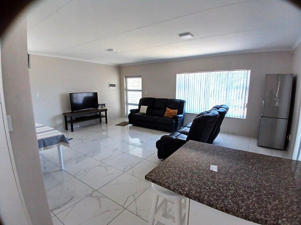Same Spacious open plan Living Area (with front door at the back) - as from Kitchen.