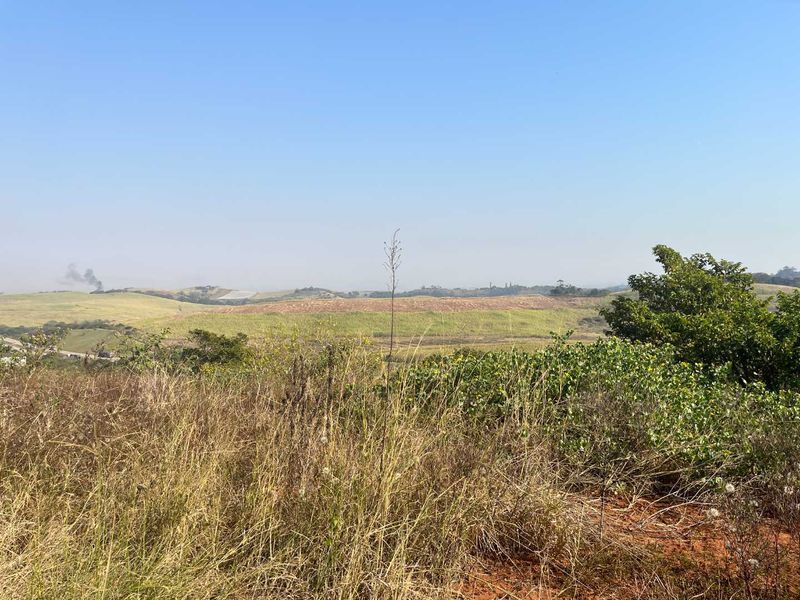 A scenic view overlooking rolling hills and agricultural land, showcasing the natural landscape and open space of the property.
