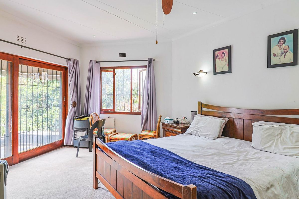Spacious bedroom featuring carpeted flooring, recessed lighting, a ceiling fan, and a sliding glass door providing access to the outdoor area.