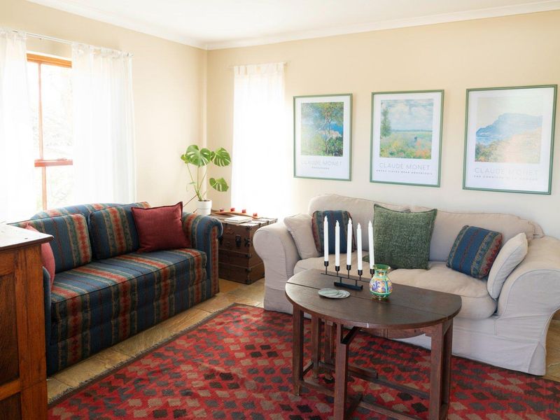 A comfortable living room featuring tiled flooring and neutral wall finishes, offering a bright and inviting space for relaxation.
