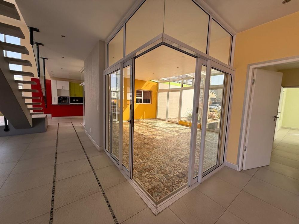 Sunroom and, on the right, a door leading to the flatlet/ ground floor room