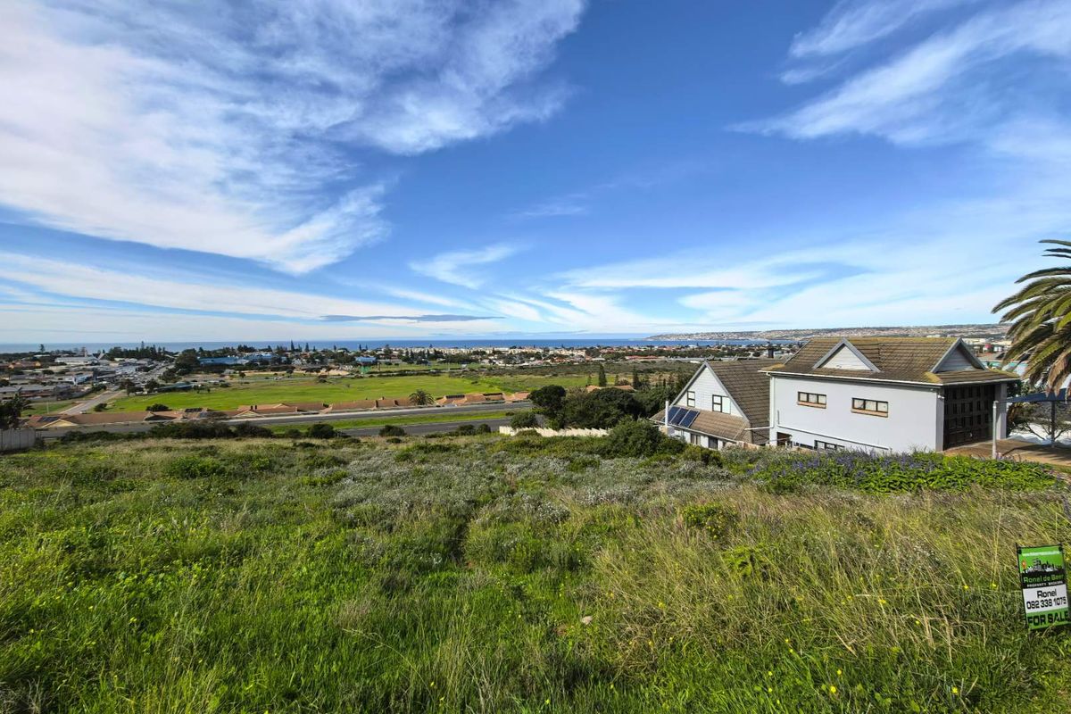 Elevated view overlooking the surrounding residential area and coastline from the vacant residential plot.