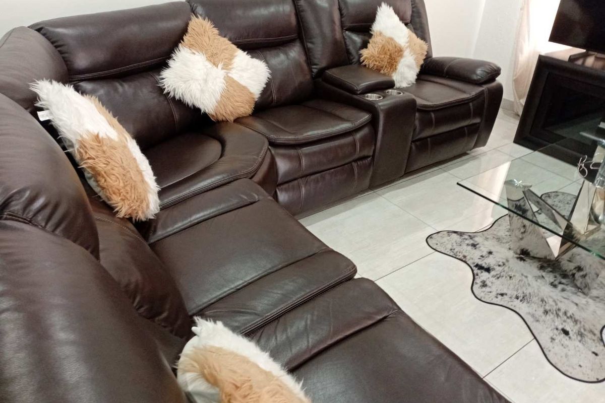 A living room area featuring neutral tiled flooring and a spacious layout.