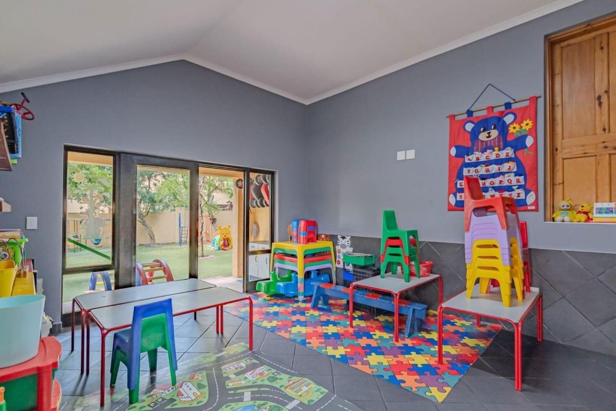 Spacious room with tiled flooring and large sliding glass doors providing direct access to the rear garden area.