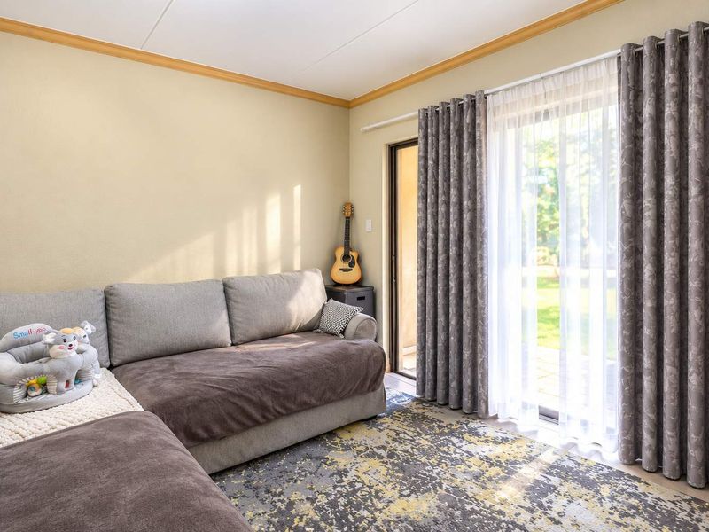 A comfortable living room featuring a large sliding glass door that provides natural light and direct access to the outdoor area.