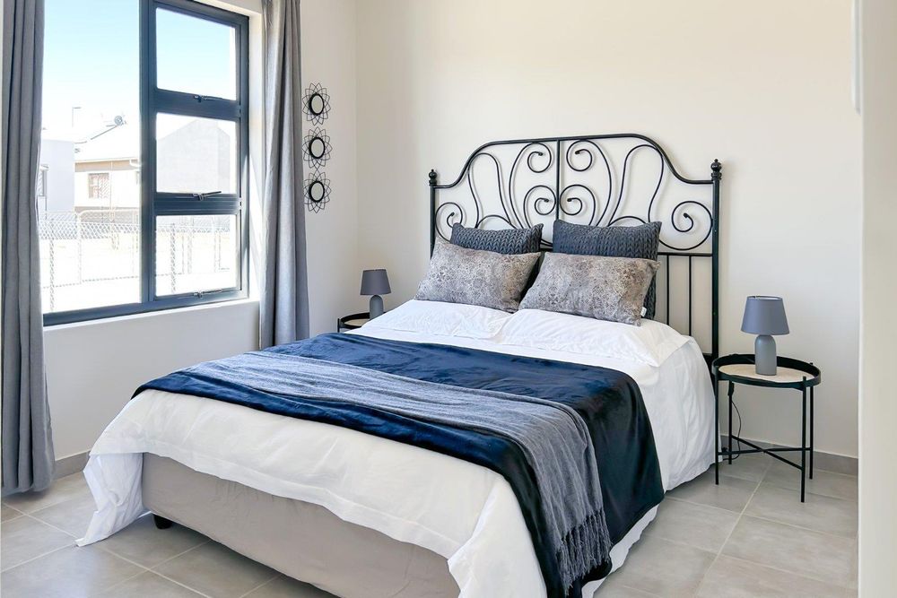Main bedroom with built-in cupboards and ensuite bathroom.