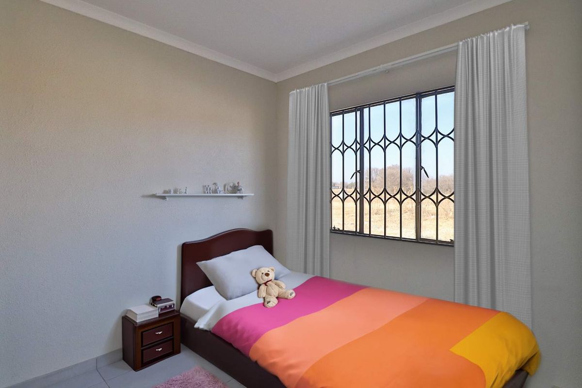 A bedroom featuring tiled flooring, a window with security bars, and neutral wall finishes.
