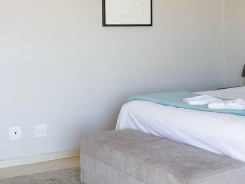 A well-maintained bedroom featuring neutral wall finishes, standard electrical points, and clean skirting boards.