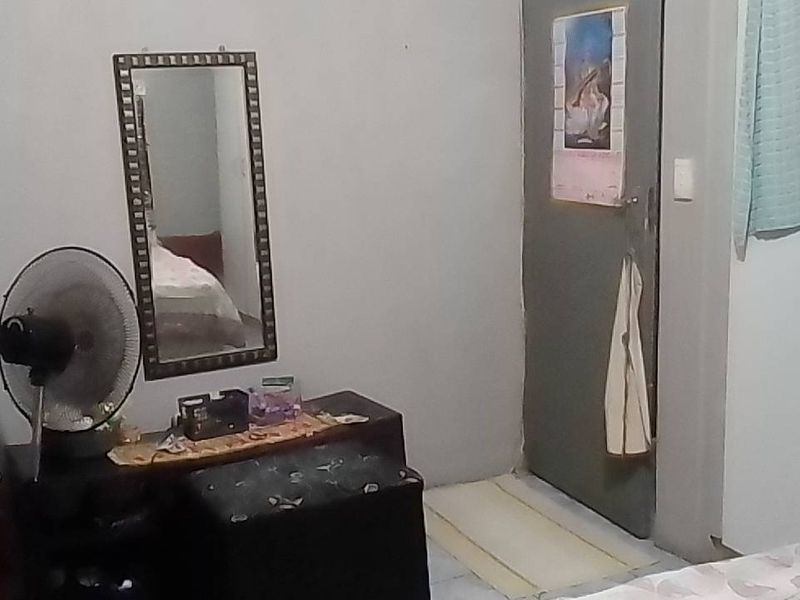 A bedroom featuring a built-in wardrobe and standard finishes, requiring cosmetic updates to enhance its appeal.