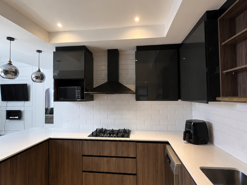Modern kitchen featuring wood grain cabinetry, quartz countertops, subway tile backsplash, gas hob, extractor fan, and integrated appliances.