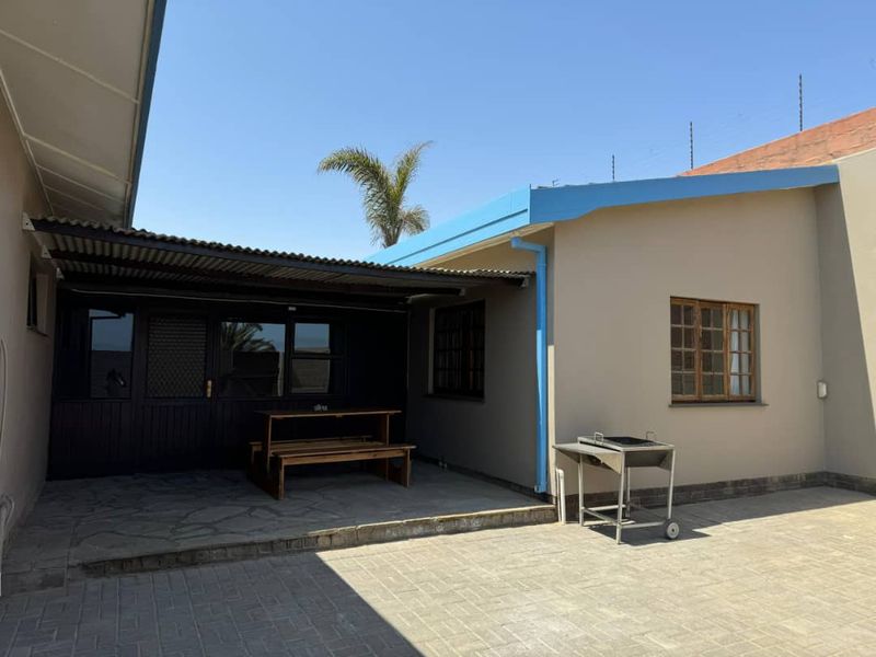 A covered outdoor patio area featuring paved flooring and direct access to the home, suitable for outdoor dining and entertainment.