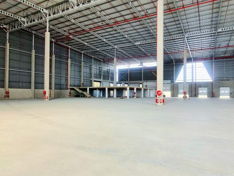 Spacious industrial warehouse featuring a high-clearance steel portal frame, polished concrete flooring, integrated fire suppression systems, and a mezzanine level for additional utility.