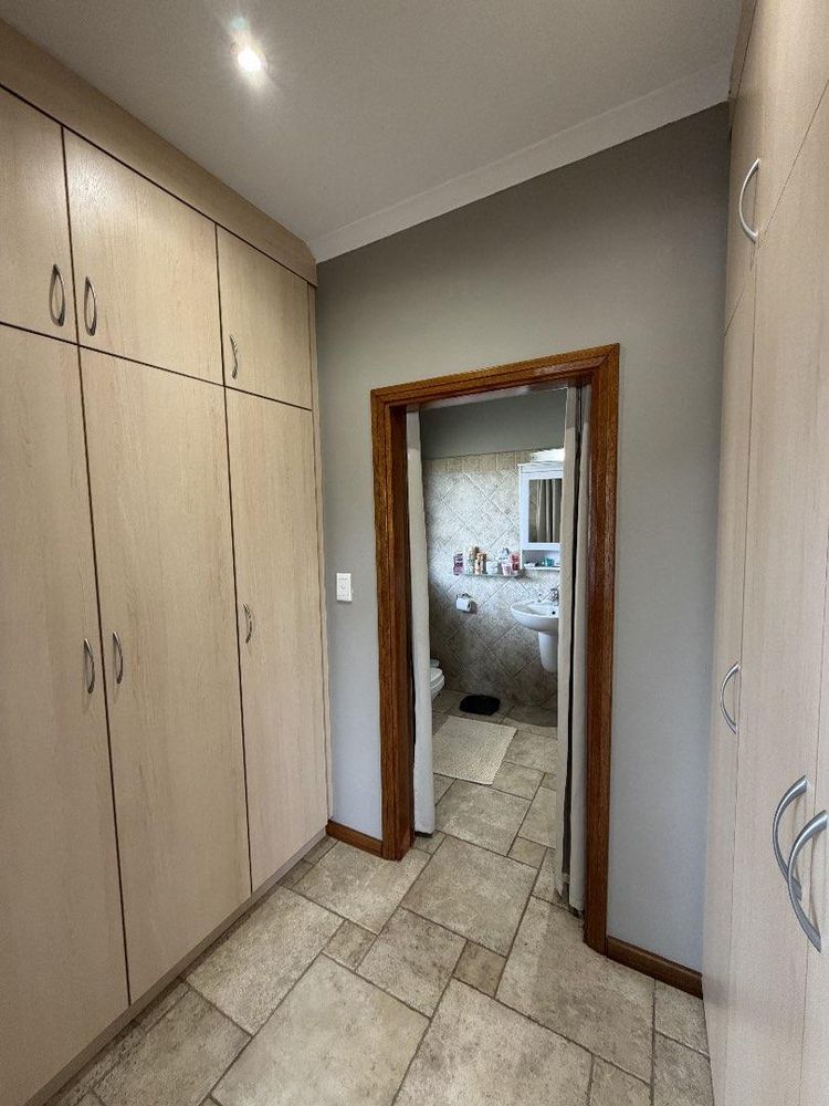 Main bedroom cupboard space leading to en-suite bathroom