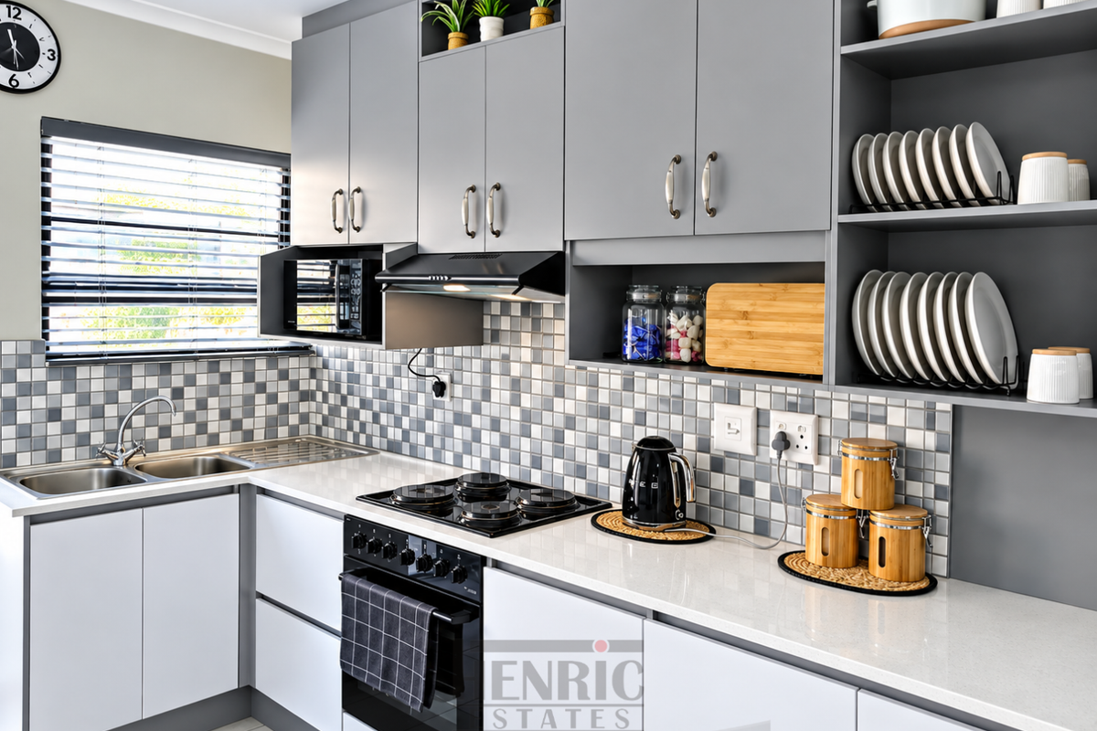 Modern kitchen featuring grey cabinetry, quartz countertops, mosaic tile backsplash, and integrated appliances including a gas hob and built-in oven.
