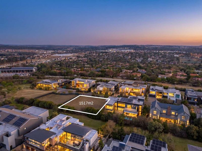 An aerial view of a 1517m2 vacant residential plot situated within an established luxury estate, surrounded by modern homes.
