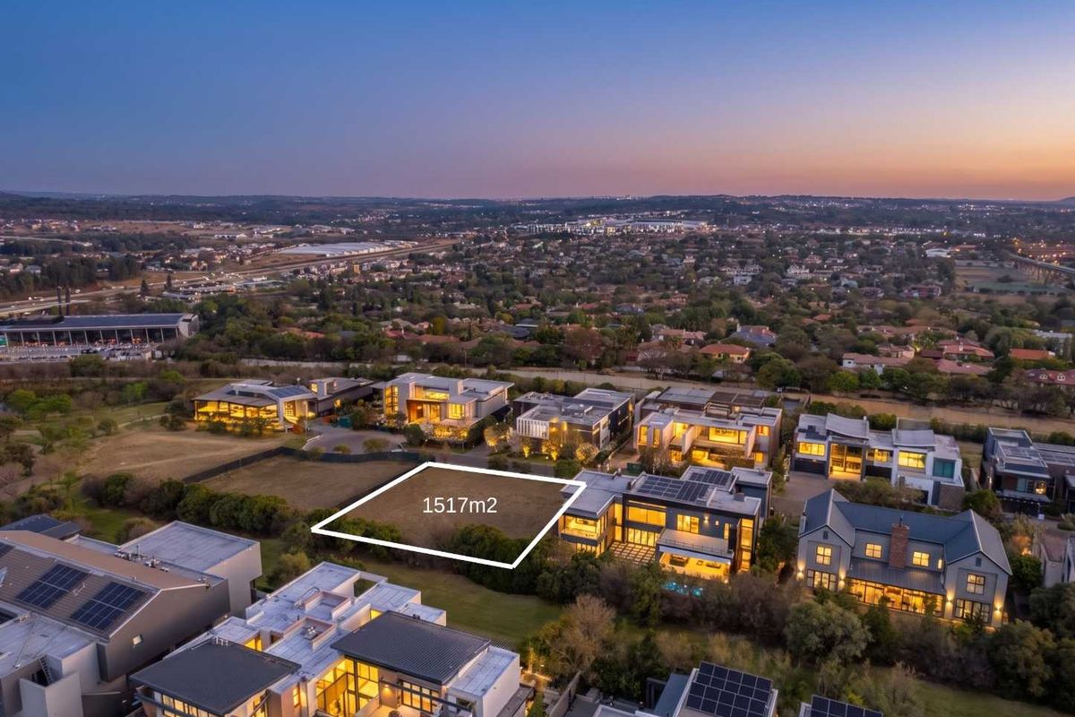 An aerial view of a 1517m2 vacant residential plot situated within an established luxury estate, surrounded by modern homes.