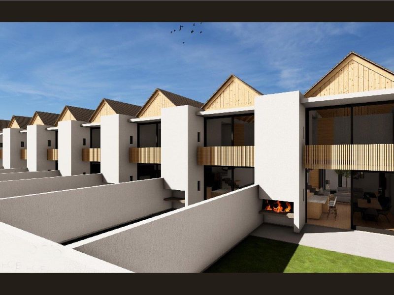 A 3D architectural rendering of a row of modern townhouses featuring private rear patios with built-in fireplaces and upper-level balconies.