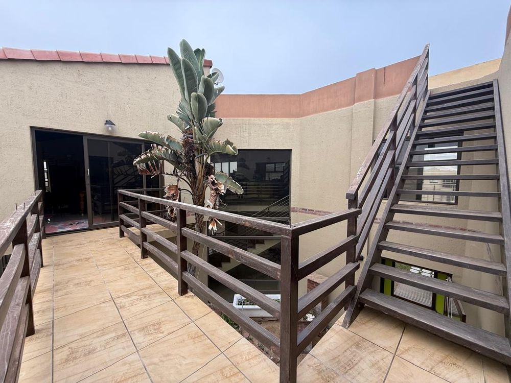 Balcony walkway between the lounge and first floor bedrooms. Staircase leading to the rooftop