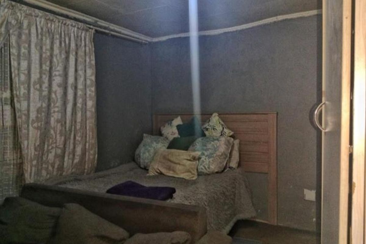 A compact bedroom featuring a built-in cupboard and basic finishes, offering potential for cosmetic updates to enhance the living space.