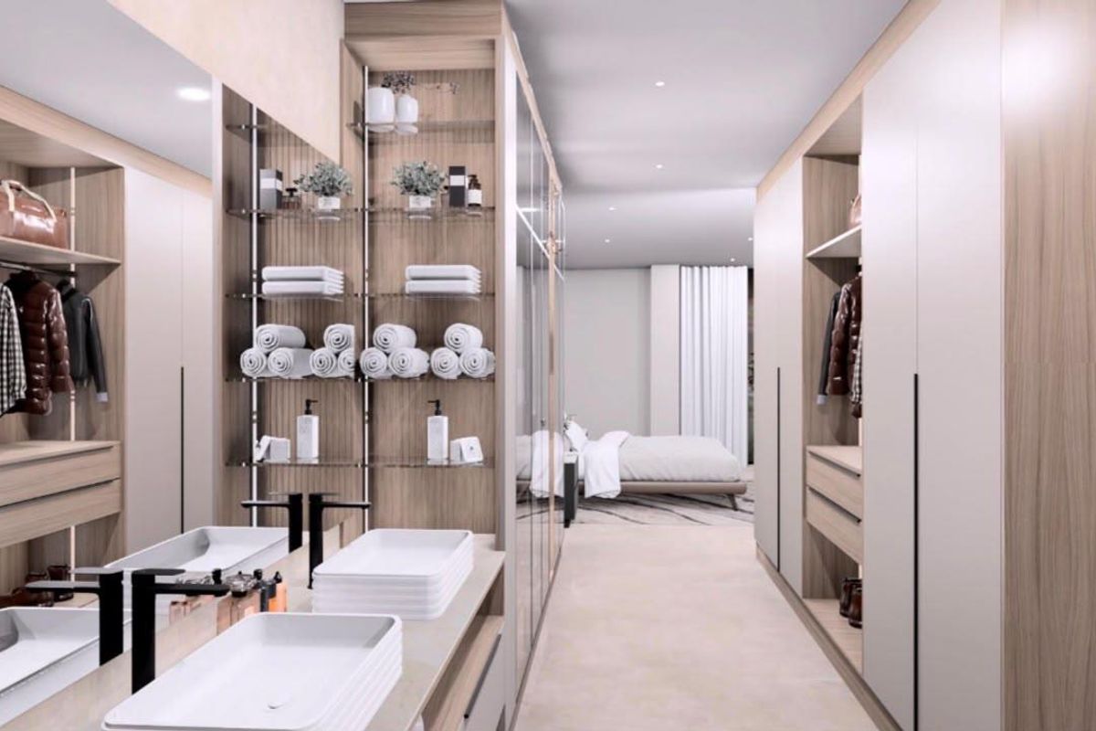 A modern, high-end walk-in closet and dressing area featuring custom built-in cabinetry, integrated shelving, and a sleek double vanity with contemporary fixtures.