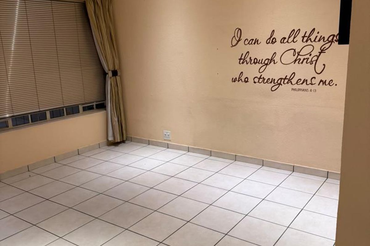 An empty bedroom featuring tiled flooring, a ceiling fan, and recessed lighting, providing a blank canvas for personalization.