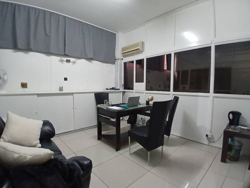 A functional office space featuring tiled flooring, built-in cabinetry, and an integrated air conditioning unit, suitable for professional business use.