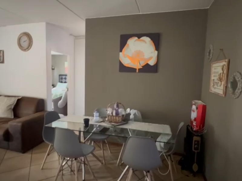 Open plan living and dining area featuring tiled flooring, providing a functional space for relaxation and meals.