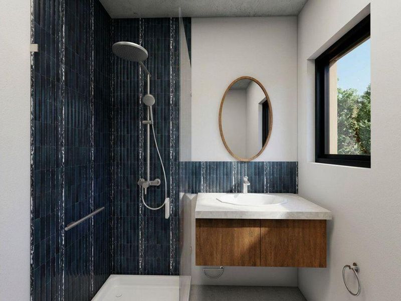 Modern bathroom featuring a walk-in shower with dark blue vertical tiling, a floating wooden vanity with stone countertop, and a sleek basin.