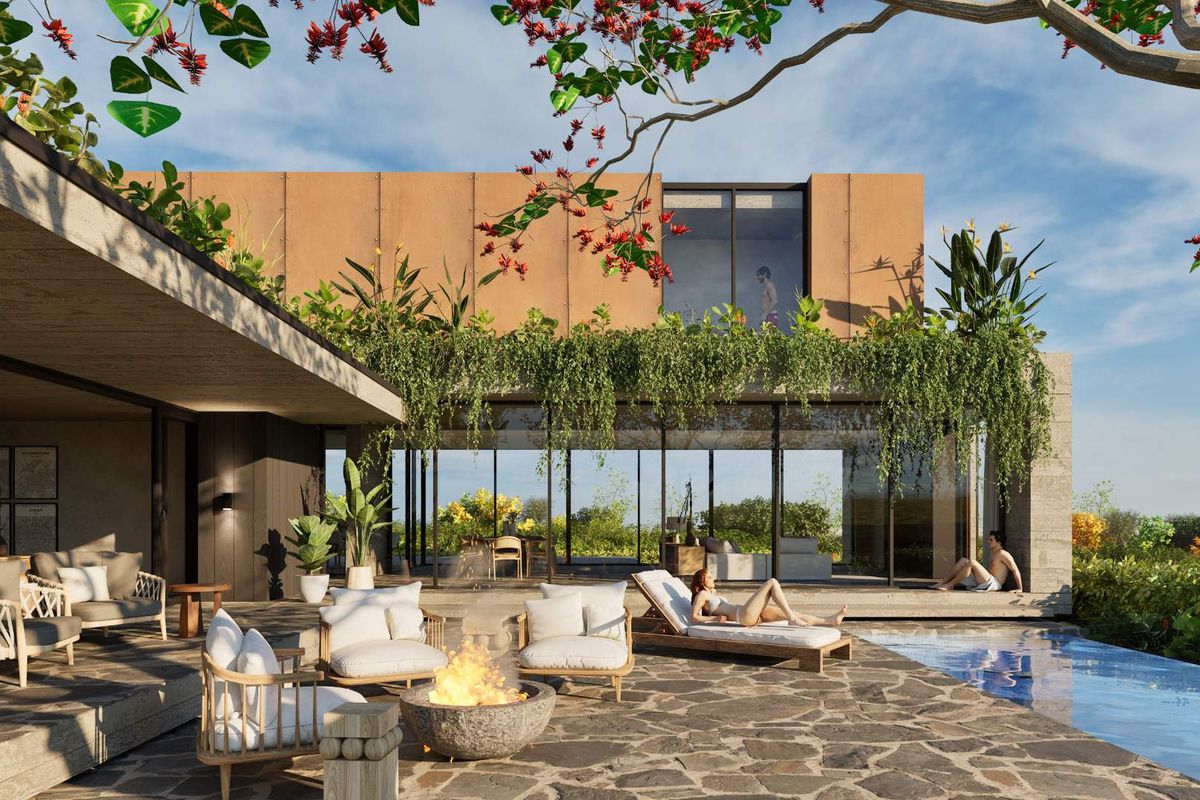 A luxurious outdoor pool area featuring a stone-paved patio, modern architectural design, and seamless indoor-outdoor flow through large glass sliding doors.