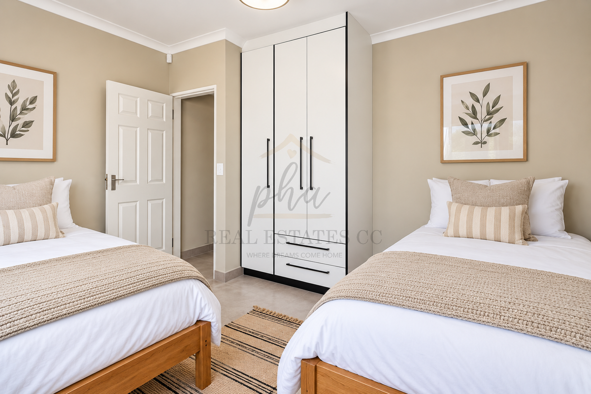 A well-maintained bedroom featuring neutral wall tones, tiled flooring, and a modern built-in wardrobe with clean lines.