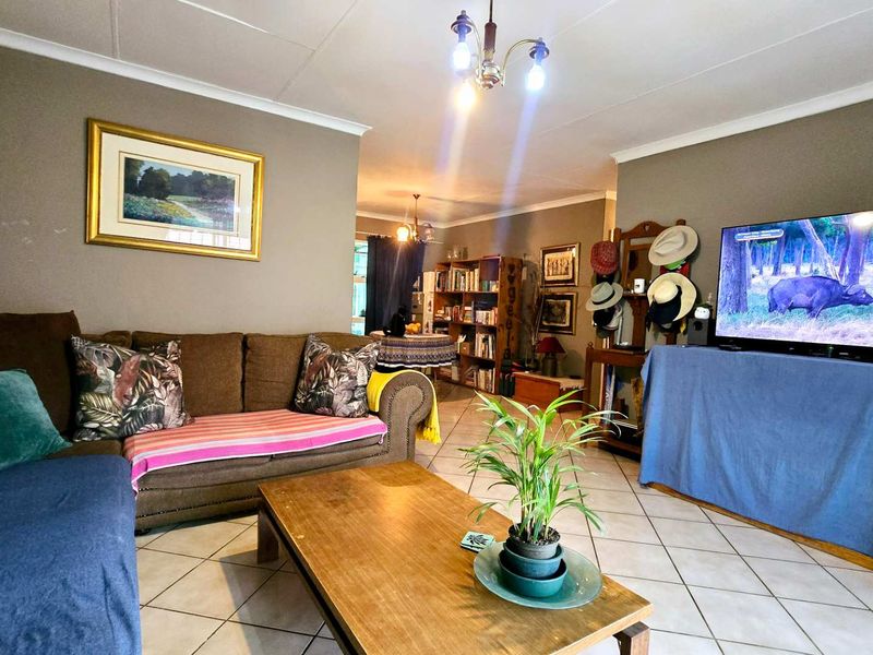 A comfortable living room featuring tiled flooring and neutral wall tones, providing a functional space for relaxation and entertainment.