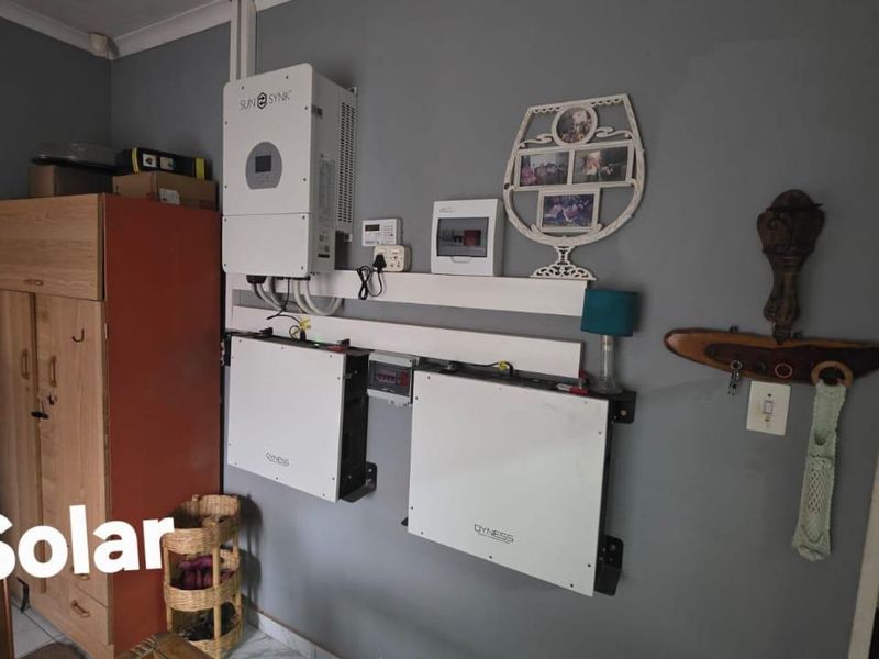 Wall-mounted solar power system featuring a Sunsynk inverter and dual Dyness lithium-ion battery storage units for residential energy management.