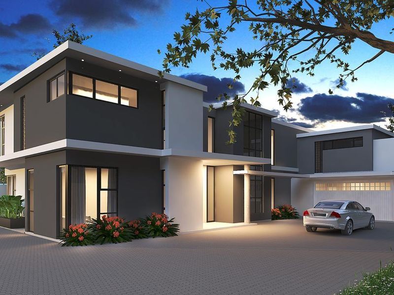 A modern double-story cluster home featuring a sleek dark and light grey facade, paved driveway, and integrated double garage at twilight.