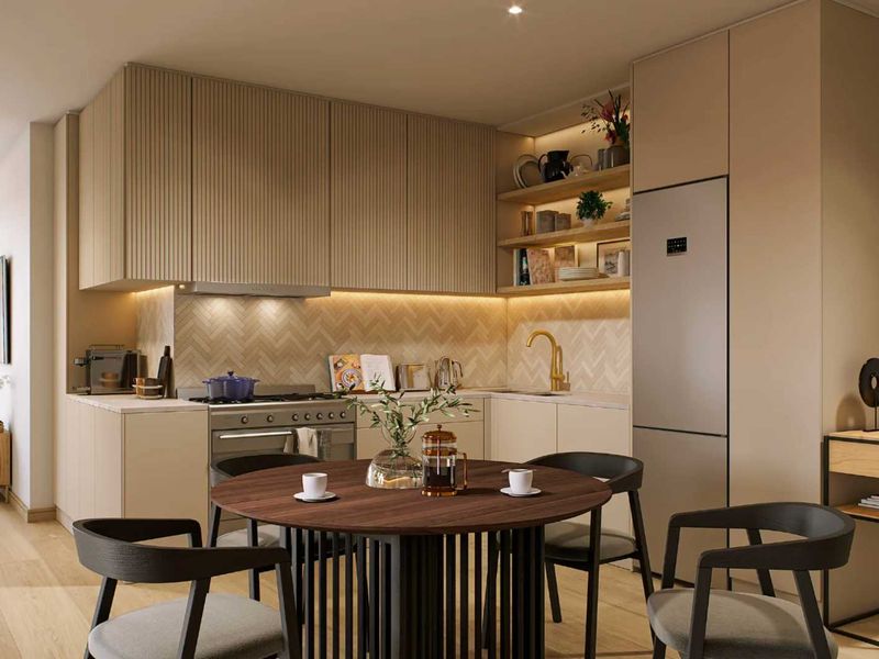 Modern open-plan kitchen featuring fluted cabinetry, herringbone backsplash, integrated appliances, and warm recessed lighting, seamlessly flowing into the living area with balcony access.