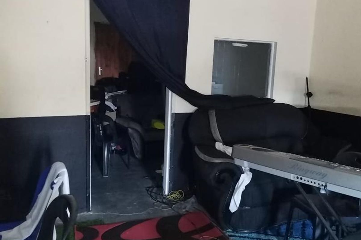 Interior view of a multi-purpose room featuring basic wall finishes and a doorway leading to an adjacent space.