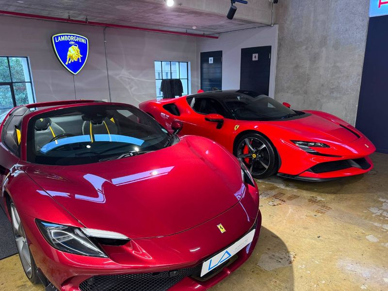 A modern, industrial-style garage space featuring exposed concrete ceilings, polished concrete floors, and clean wall finishes.