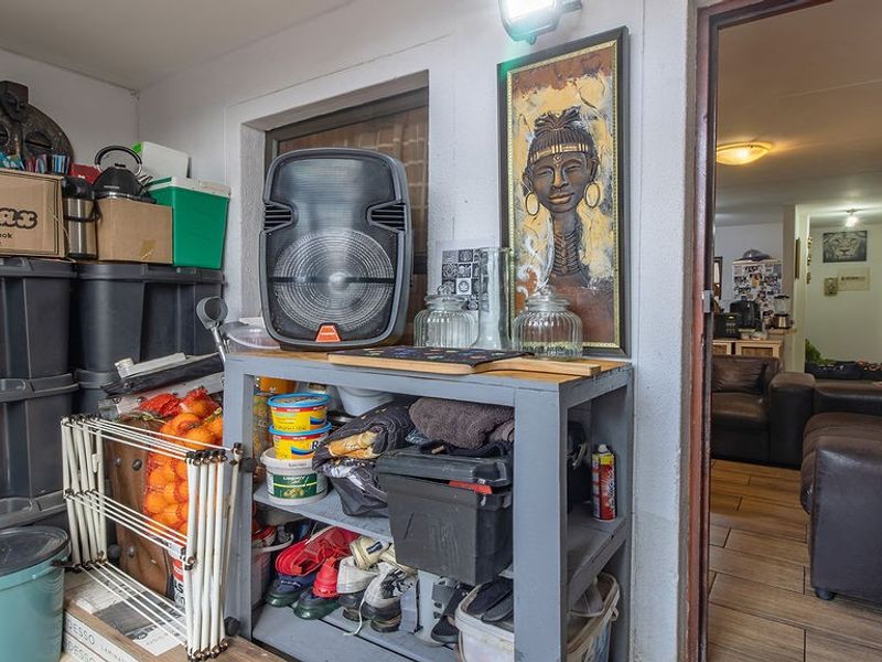 A covered patio area featuring tiled flooring and direct access into the main living space of the apartment.
