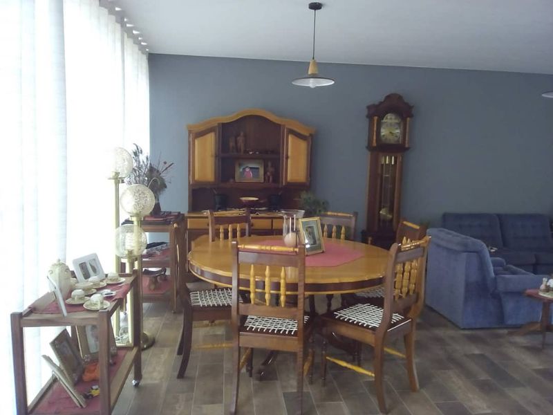 A dining area featuring wood-look tile flooring and modern pendant lighting, providing a functional space for meals.