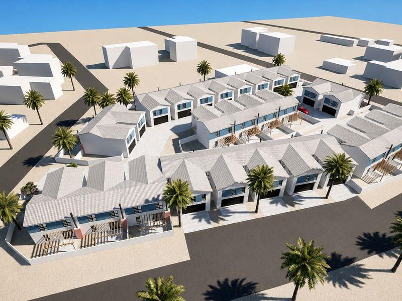 An aerial 3D render of a modern townhouse development featuring multiple units with pitched roofs, private driveways, and landscaped outdoor spaces.