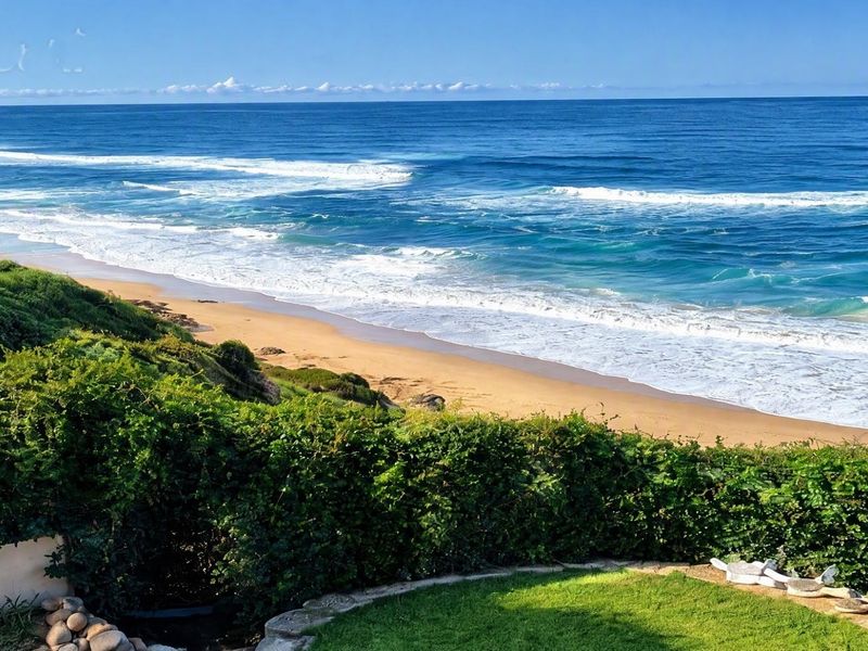A scenic elevated view overlooking the coastline, sandy beach, and ocean waves.