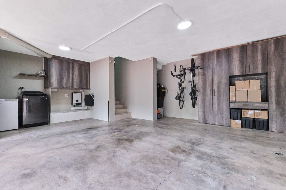 Garage with built-in-cupboards, laundry and backup power system.