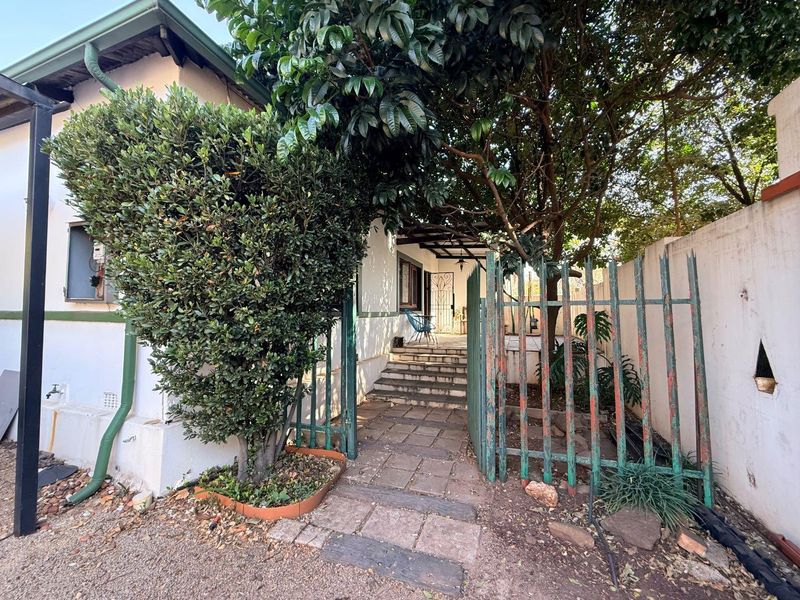 Charming 2-Bed Home with Two Bonus Units for Extra Income - Photo 1