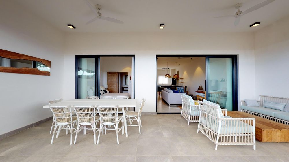 Patio with seating areas. Sliding doors leading to both the lounge and one of the bedrooms