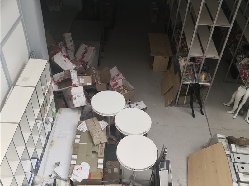 An elevated view of an industrial utility or storage space featuring built-in shelving units and a mezzanine level.