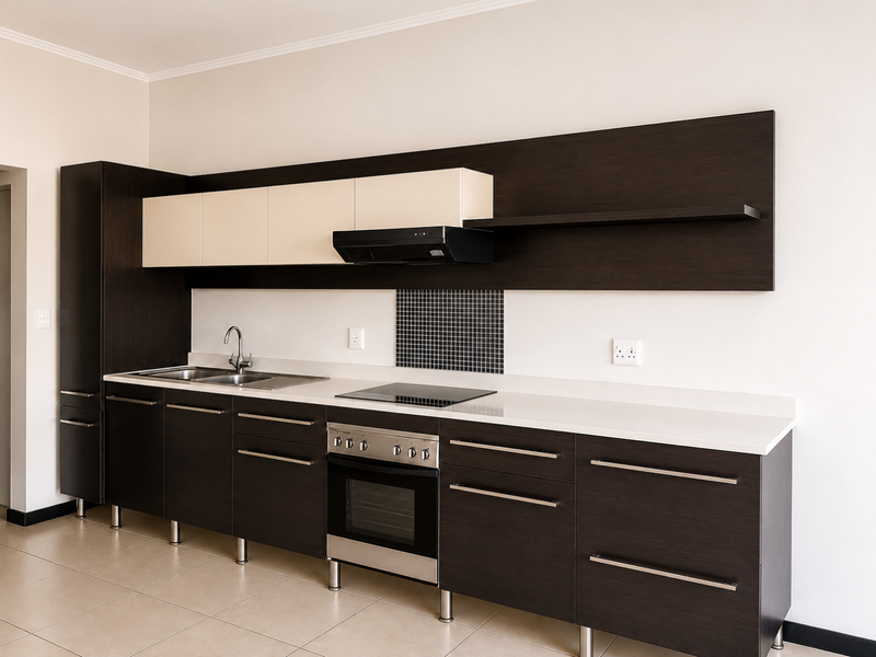 Modern kitchen featuring dark wood cabinetry, contrasting cream upper cabinets, stone countertops, integrated stainless steel appliances, and a tiled backsplash.