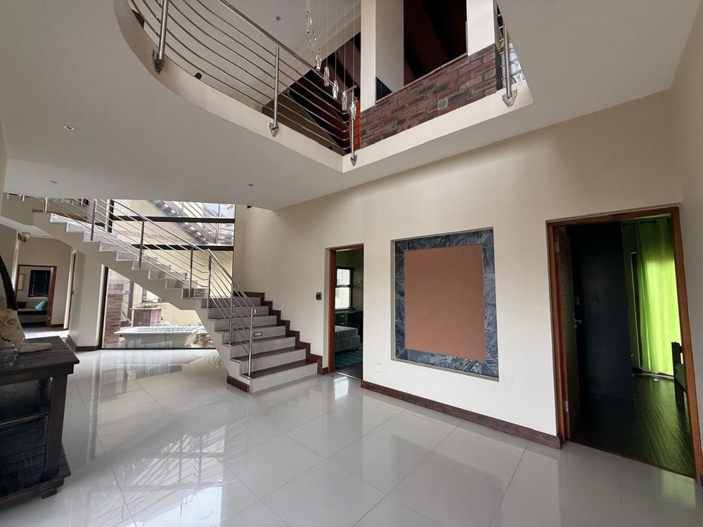 Stairs and ground floor living area, two of the three bedrooms