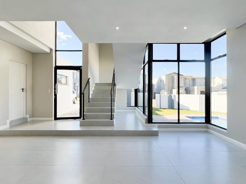 Double-Volume Elegance, Designer Finishes & Family Comfort - Photo 1